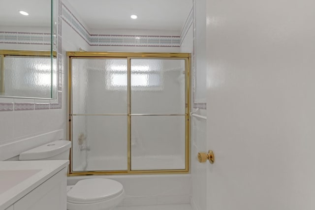 full bathroom featuring toilet, shower / bath combination with glass door, vanity, and recessed lighting