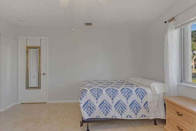 bedroom with light tile patterned floors, visible vents, and baseboards