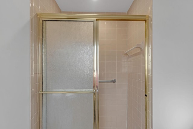 bathroom with tiled shower