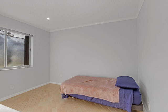 bedroom with crown molding, recessed lighting, wood finished floors, and baseboards