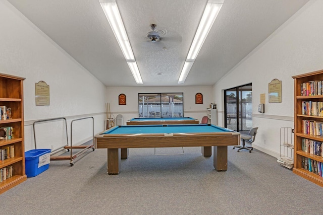 rec room with carpet floors, pool table, wainscoting, vaulted ceiling, and a textured ceiling