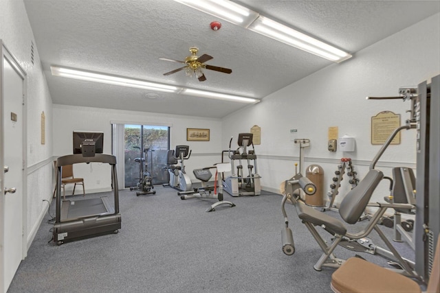 workout area featuring ceiling fan and a textured ceiling