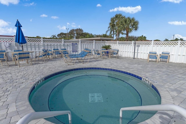 view of pool featuring a patio area, fence, and a swimming pool