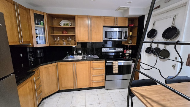 3100 N Palm Aire Dr Unit 604, Pompano Beach, FL 33069 - kitchen with light tile patterned flooring, appliances with stainless steel finishes, sink, and tasteful backsplash