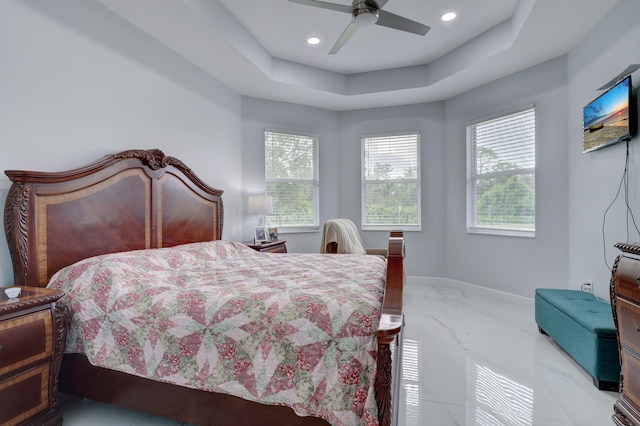 bedroom with marble finish floor, recessed lighting, a raised ceiling, ceiling fan, and baseboards