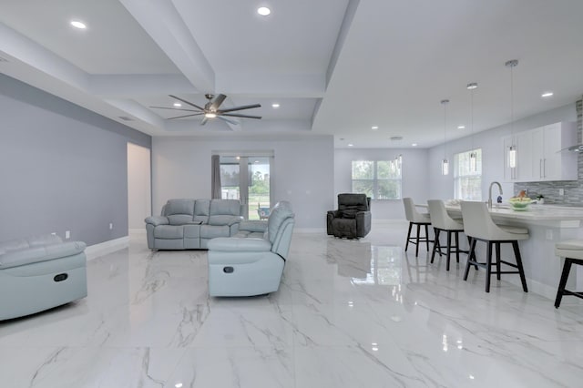 living room with baseboards, marble finish floor, and recessed lighting