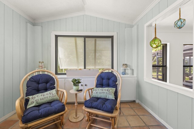 306 Fernandina St, Fort Pierce, FL 34949 - sitting room featuring ornamental molding, plenty of natural light, lofted ceiling, and wood walls