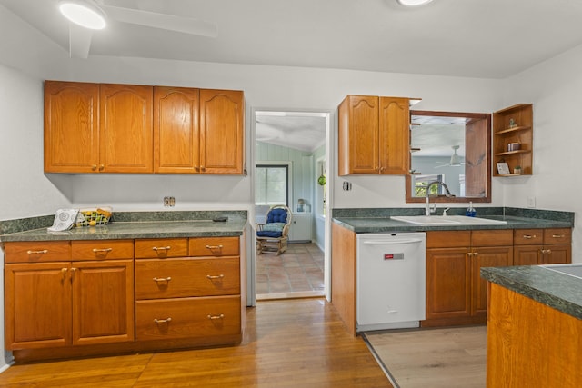 306 Fernandina St, Fort Pierce, FL 34949 - kitchen featuring white dishwasher, a sink, dark countertops, and brown cabinetry