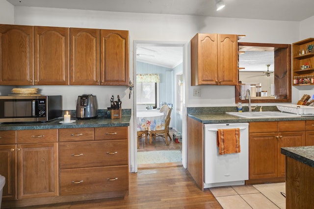 kitchen featuring dishwasher, open shelves, stainless steel microwave, and dark countertops