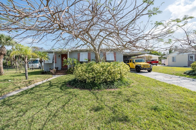 view of front facade featuring driveway, a front lawn, a carport, and stucco siding