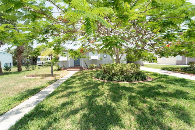 306 Fernandina St, Fort Pierce, FL 34949 - view of front of house featuring a front lawn and stucco siding