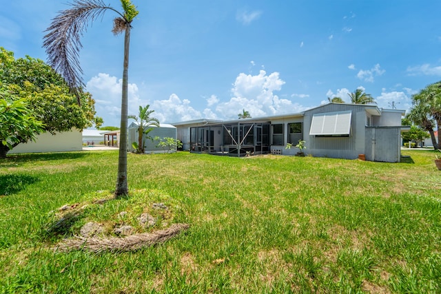 306 Fernandina St, Fort Pierce, FL 34949 - rear view of house featuring a lawn