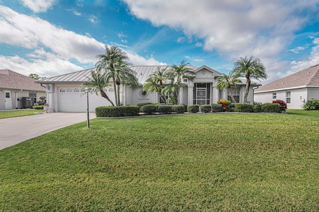 view of front of home with driveway, metal roof, an attached garage, a standing seam roof, and a front yard