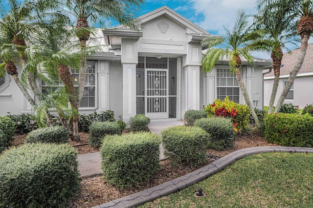 view of exterior entry featuring stucco siding