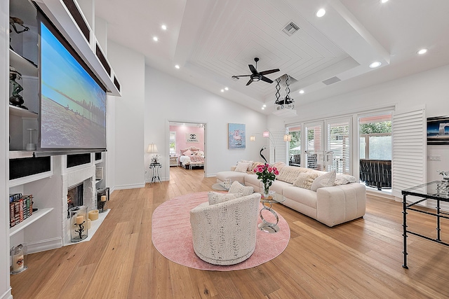 living area featuring visible vents, a fireplace with flush hearth, light wood-style flooring, a ceiling fan, and recessed lighting