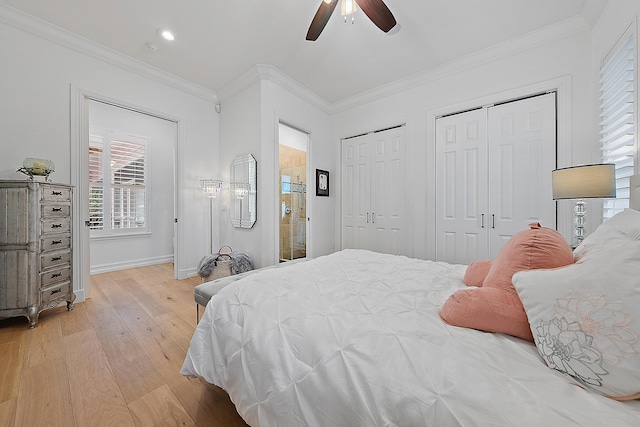 bedroom with light wood-type flooring, multiple closets, baseboards, and ornamental molding