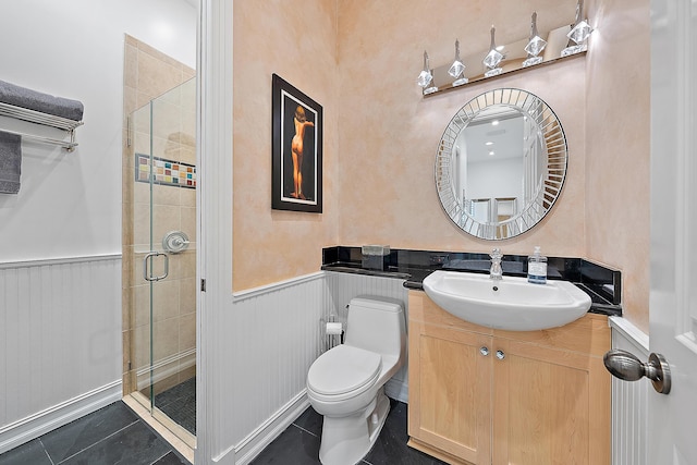 full bathroom featuring vanity, a shower stall, wainscoting, tile patterned floors, and toilet