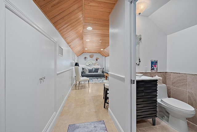 bathroom featuring visible vents, vaulted ceiling, wainscoting, wooden ceiling, and toilet