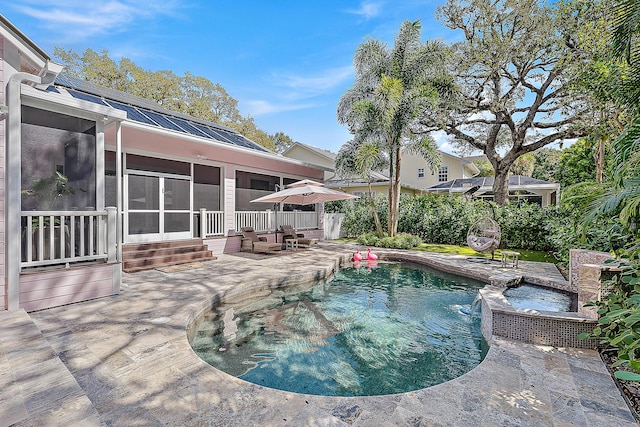 pool featuring a patio area and a sunroom