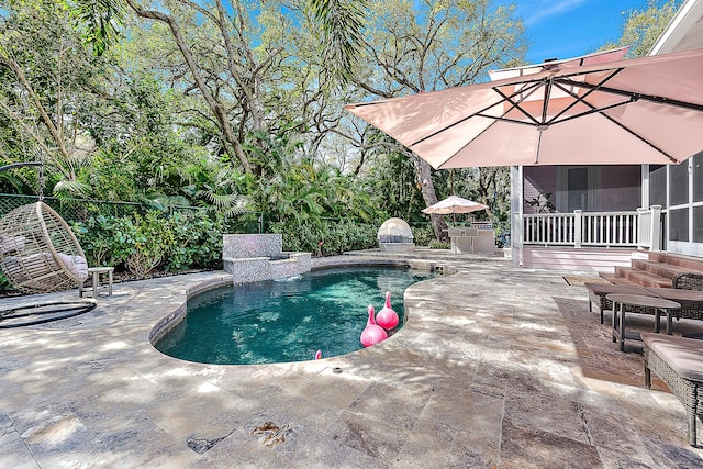 outdoor pool with a sunroom, a patio, and fence