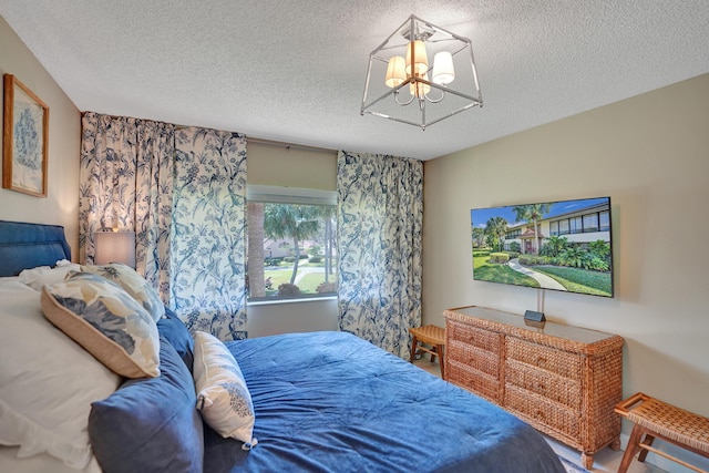 bedroom featuring a chandelier and a textured ceiling