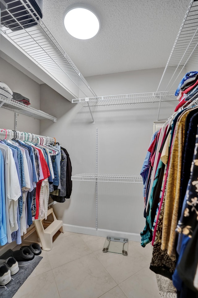 spacious closet with tile patterned floors