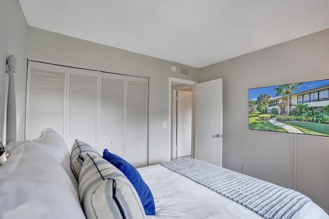 bedroom with a closet and visible vents