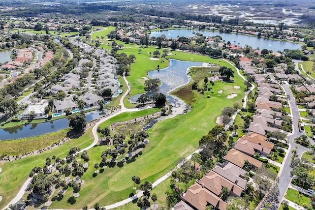 aerial view with a residential view, view of golf course, and a water view