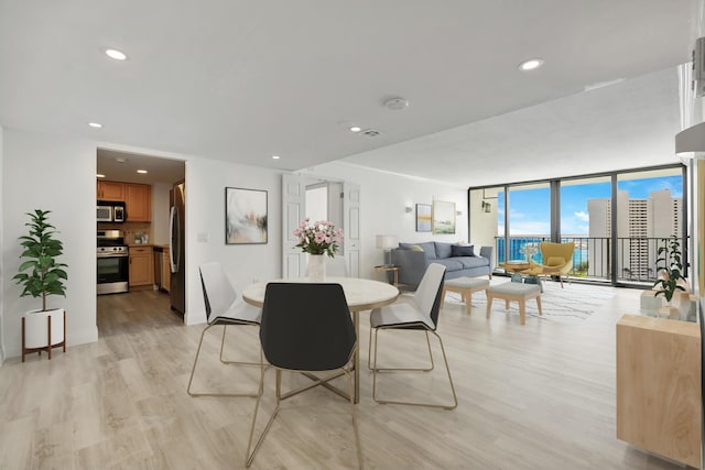 5600 N Flagler Dr Unit 1605, West Palm Beach, FL 33407 - dining space featuring a wall of windows, light wood-type flooring, and recessed lighting