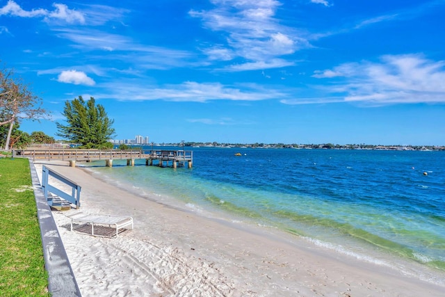 dock area featuring a water view and a view of the beach