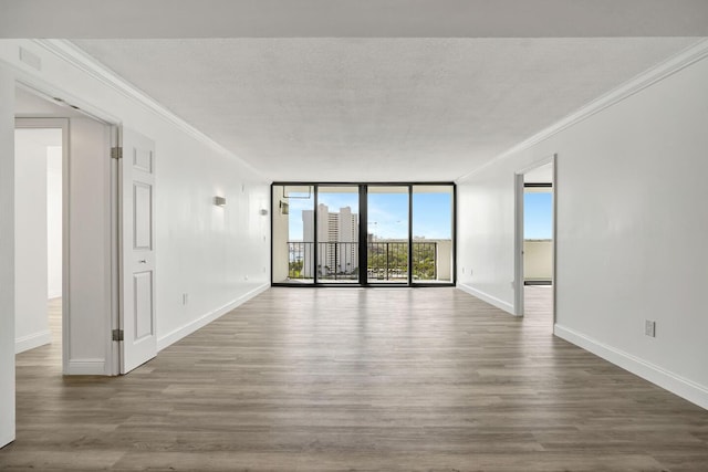 5600 N Flagler Dr Unit 1605, West Palm Beach, FL 33407 - spare room featuring expansive windows, baseboards, crown molding, and wood finished floors