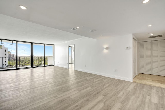 5600 N Flagler Dr Unit 1605, West Palm Beach, FL 33407 - empty room with expansive windows, baseboards, visible vents, and light wood finished floors