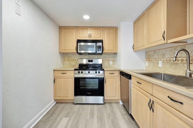 5600 N Flagler Dr Unit 1605, West Palm Beach, FL 33407 - kitchen featuring a sink, stainless steel appliances, light brown cabinets, and light wood-style floors