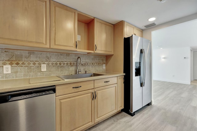 5600 N Flagler Dr Unit 1605, West Palm Beach, FL 33407 - kitchen with light brown cabinets, appliances with stainless steel finishes, and a sink