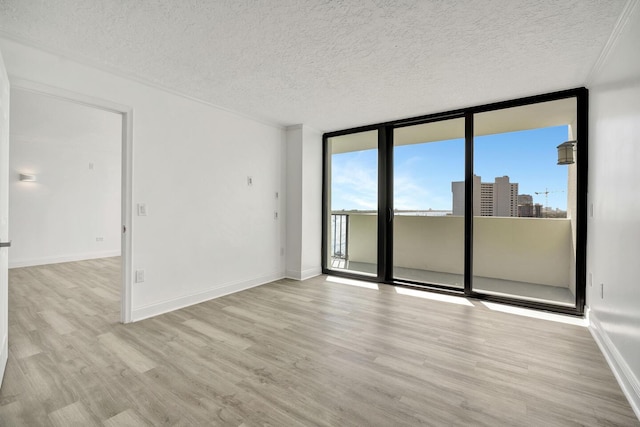 5600 N Flagler Dr Unit 1605, West Palm Beach, FL 33407 - unfurnished room with expansive windows, a textured ceiling, and wood finished floors