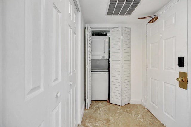 5600 N Flagler Dr Unit 1605, West Palm Beach, FL 33407 - hall featuring baseboards, visible vents, and stacked washer / dryer