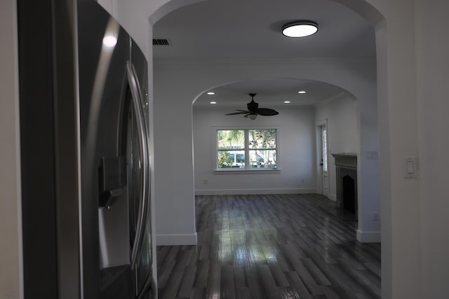 interior space featuring recessed lighting, dark wood-type flooring, visible vents, baseboards, and crown molding