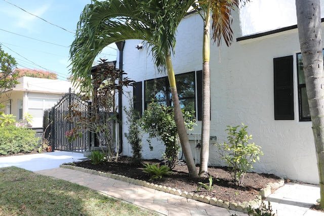 view of property exterior featuring a gate and stucco siding