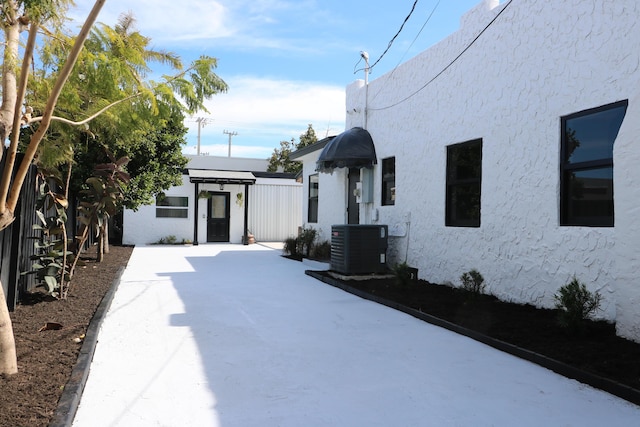 exterior space featuring central AC and stucco siding