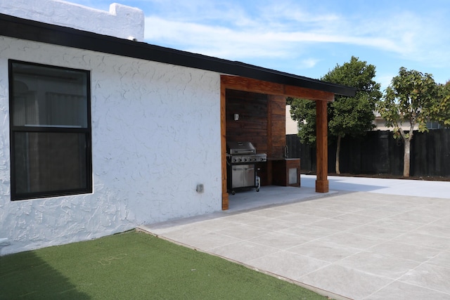 view of patio with fence and grilling area