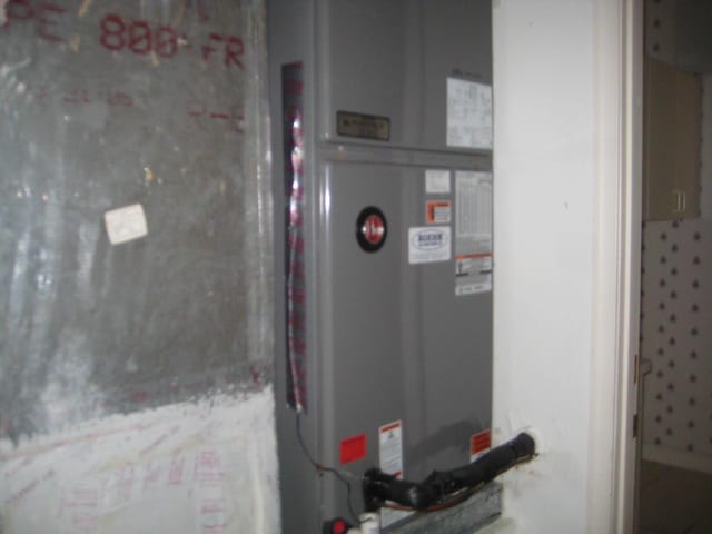 utility room featuring heating unit