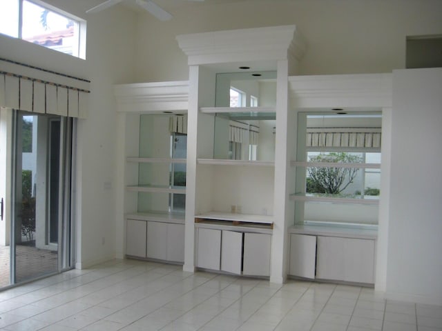 interior space with ceiling fan and a high ceiling