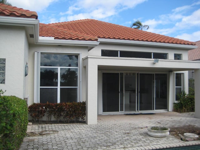 back of property featuring a patio area