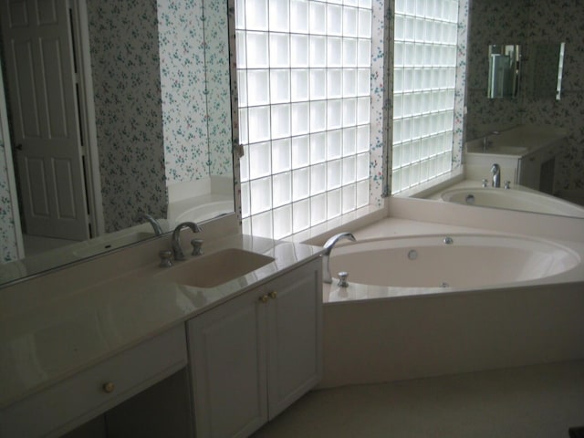 bathroom featuring a tub and vanity