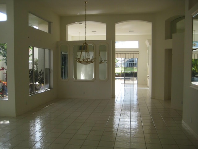 interior space featuring a high ceiling and a notable chandelier