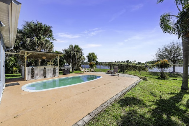 view of pool featuring a patio, area for grilling, and a lawn