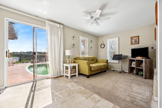 living room featuring ceiling fan and light colored carpet