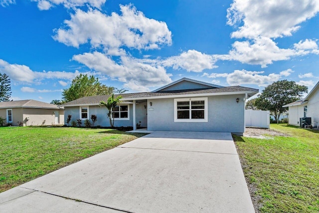 single story home featuring a front lawn