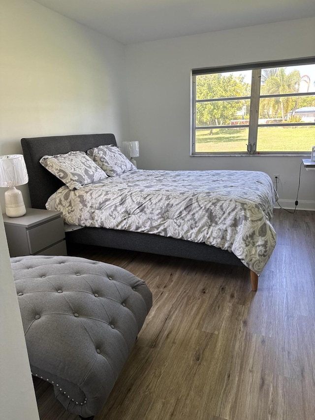 bedroom featuring baseboards and wood finished floors