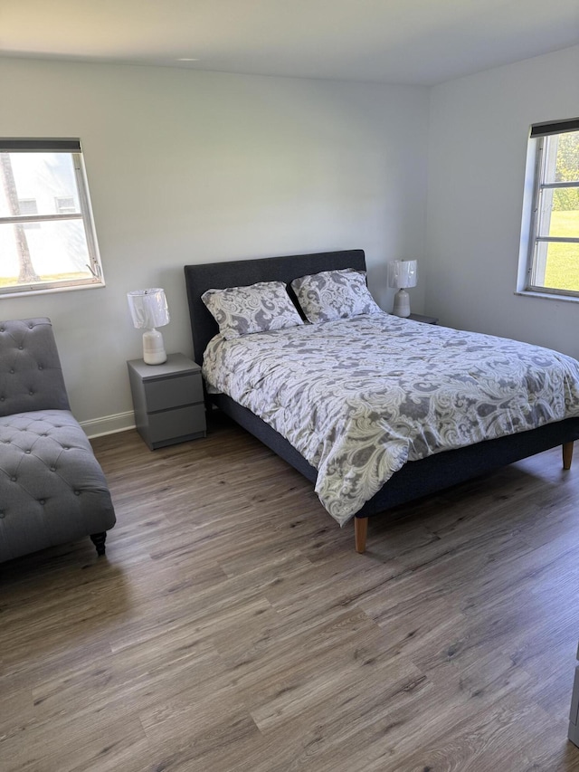 bedroom featuring baseboards and wood finished floors